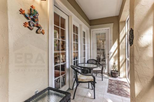 a room with a table and chairs on a porch at Gated Villas at Summer Beach in Amelia Island