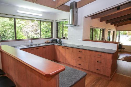 a large kitchen with wooden cabinets and a counter top at Haus On Houghs in Bright