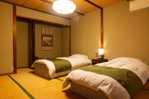 Cama o camas de una habitación en 明石家