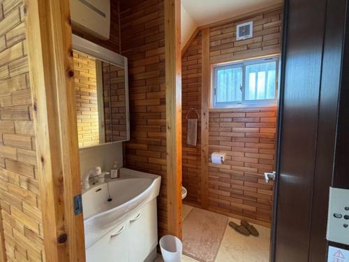 a bathroom with a sink and a toilet in a room at uliuli in Kuka