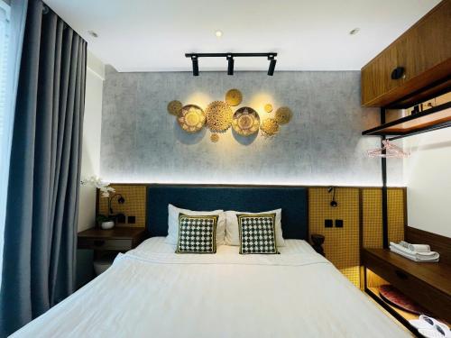 a bedroom with a white bed with two pillows at Apec Mandala Phú Yên - Luxury Codotel in Phước Hậu