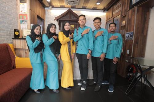a group of people posing for a picture at DJ Citi Point Hotel in Kuala Terengganu