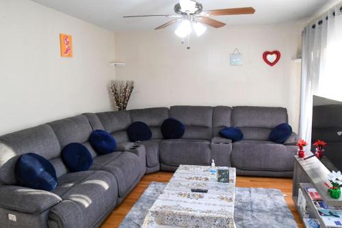 a living room with a gray couch and a table at Home Away From Home in Skokie