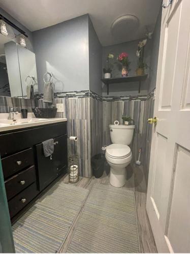 a bathroom with a toilet and a sink at Home Away From Home in Skokie