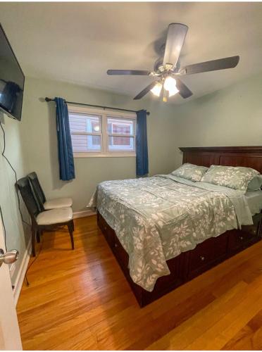 a bedroom with a bed and a ceiling fan at Home Away From Home in Skokie