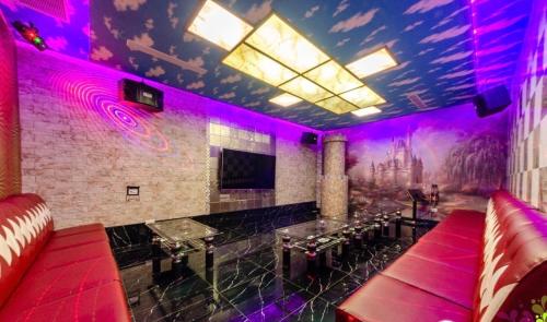 a room with purple lighting in a bar with couches at 蘭貳 宜蘭包棟民宿 in Yilan City