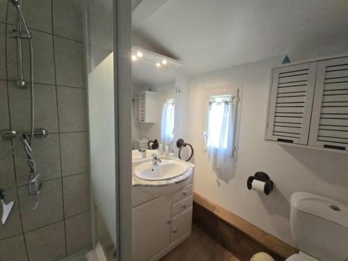 a white bathroom with a sink and a shower at Gîte Authentique avec Piscine, Cheminée et Étang Privé à Naussannes - Proche Bergerac - FR-1-616-205 in Naussannes