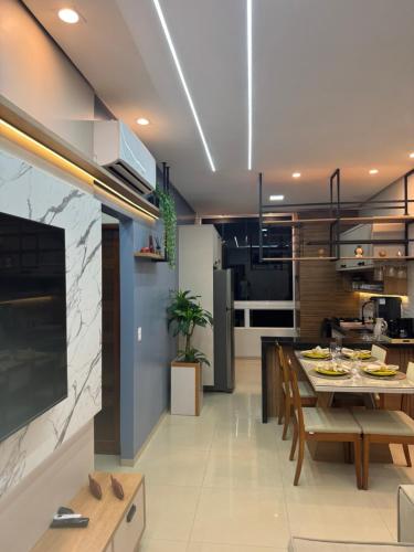 a kitchen and dining room with a dining table at Flat Alter do chão - Ilha bela Residence in Alter do Chao