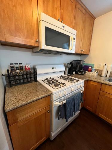 a kitchen with a stove and a microwave at Mini-Home in Whittier in Whittier