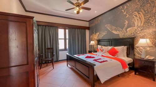 Ένα ή περισσότερα κρεβάτια σε δωμάτιο στο Retreat Indochine d'Angkor