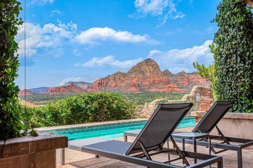 two chairs and a pool with a view of the mountains at Sedona Luxury with 75’ Lap Pool, Hot Tub & Breathtaking Vortex Views in Sedona