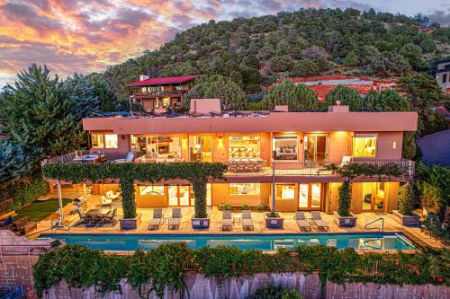 a house with a pool in front of a mountain at Sedona Luxury with 75’ Lap Pool, Hot Tub & Breathtaking Vortex Views in Sedona