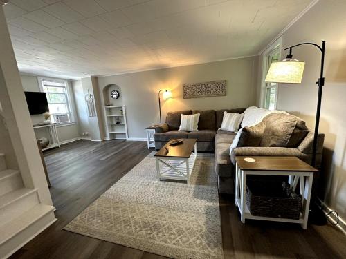 a living room with a couch and a table at Comfy Classic Cute Apartment in Watertown