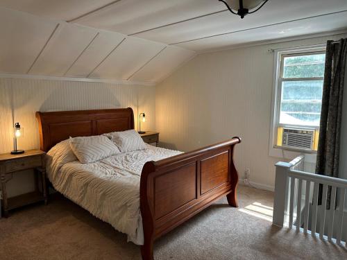 a bedroom with a bed and a window at Comfy Classic Cute Apartment in Watertown