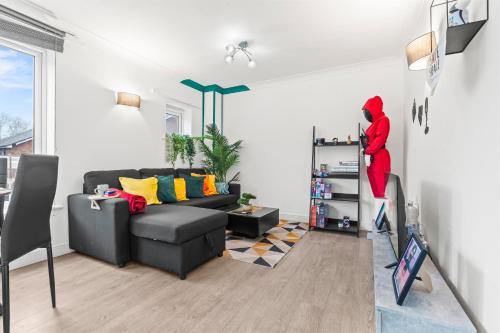a man in a red suit is on a shelf in a living room at 2 Cosy Bedroom Sleeps 6 02 Arena Perfect for Contractors Families and Groups in London