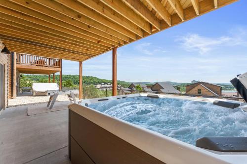 a hot tub on the patio of a house at Summertime Shores - 127 in Branson