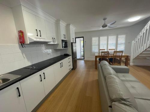 a kitchen and living room with a couch and a table at Seashells Beachfront Resort in Diamond Beach