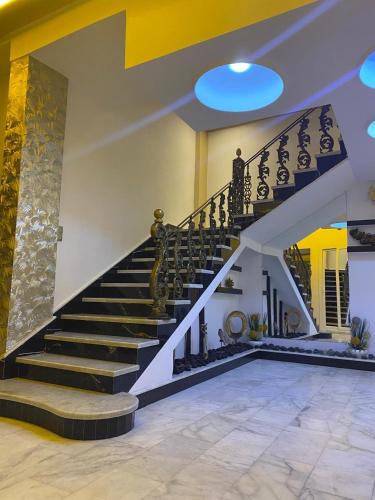 a staircase in a house with a person walking up it at Hotel Golden Star in Taounate