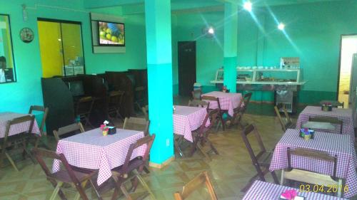 a restaurant with purple tables and chairs in a room at Hotel Chalé Ji-Parana in Ji-Paraná