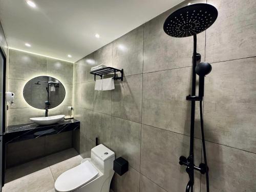 a bathroom with a toilet and a sink and a mirror at LION 15 Hotel in Can Tho