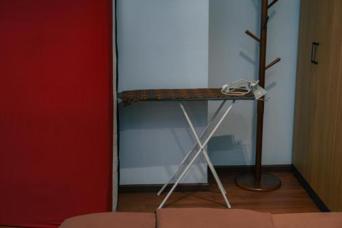 a table in a room next to a red door at The Place Cyberjaya Duplex with Putrajaya View in Cyberjaya