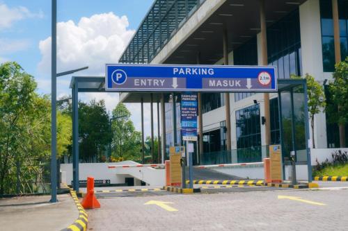 a parking sign in front of a building at The Place Cyberjaya Duplex with Putrajaya View in Cyberjaya