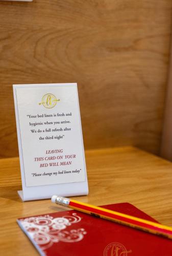 a card with a pen on top of a table at Hotel Anuttara Boudha, Kathmandu in Baudhatinchule