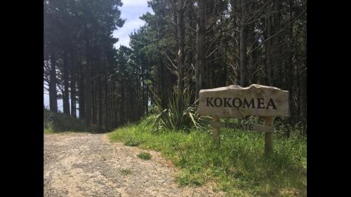 a sign on the side of a dirt road at Raglan Lovebus in Raglan