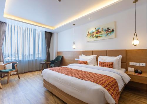 a hotel room with a bed and a desk at Hotel Anuttara Boudha, Kathmandu in Baudhatinchule