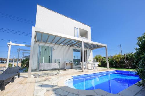 a house with a swimming pool in front of it at Pool Villa Mito - Pool Villa 水戸 in Mito