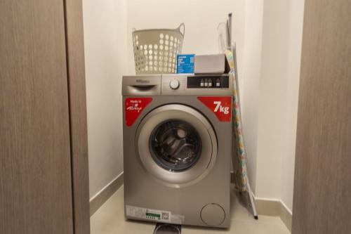 a washing machine in the corner of a room at Family Getaway Villa in Ras al Khaimah
