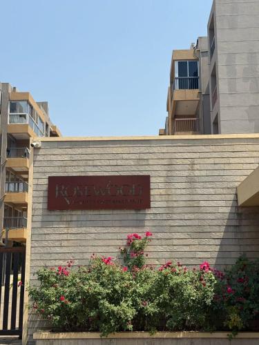 a sign on a wall with flowers and buildings at Everyplace is FULL of Everything in Igatpuri