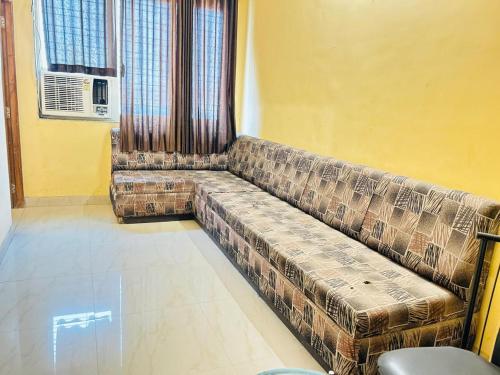 a living room with a couch in a room at Hotel Mayur Residency in Kalyan