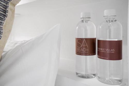two bottles of water are sitting on a shelf at The Surf Lodge Villa in Malibu