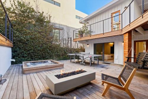 a patio with a table and a bench on a wooden deck at The Surf Lodge Villa in Malibu