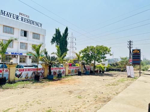a dirt road in front of a building at Hotel Mayur Residency in Kalyan