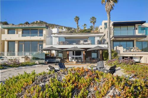 a building with chairs and umbrellas in front of it at The Surf Lodge Villa in Malibu