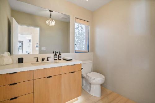 a bathroom with a toilet and a sink and a mirror at The Surf Lodge Villa in Malibu
