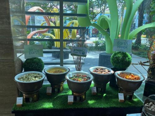 a display of different types of plants on a table at DoubleTree by Hilton Jakarta Kemayoran in Jakarta