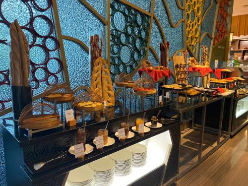 a display case in a store with plates and food at DoubleTree by Hilton Jakarta Kemayoran in Jakarta
