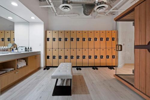 a locker room with lockers and a bench in it at The Surf Lodge Villa in Malibu