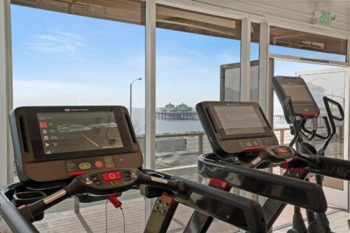 a gym with two exercise bikes with a view of the ocean at The Surf Lodge Villa in Malibu