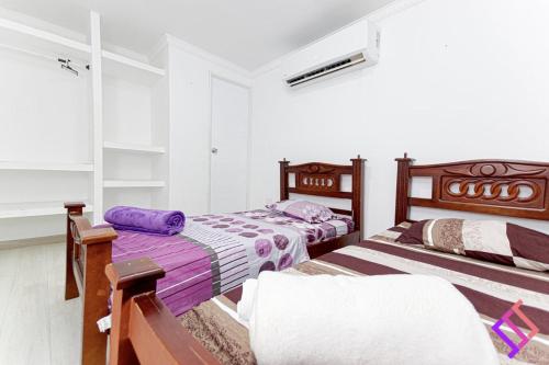 Postel nebo postele na pokoji v ubytování Guatapurí Apartamentos & Relax