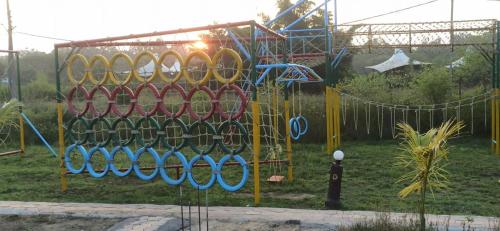 a playground with a bunch of playground equipment at Kingfisher Resort in Dhanwār