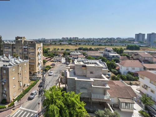 an overhead view of a city with buildings and a street at דירת 3 חדרים עם נוף פתוח ושקט מטבח מושקע וחנייה , 5 דק מאסף הרופא in Ramla