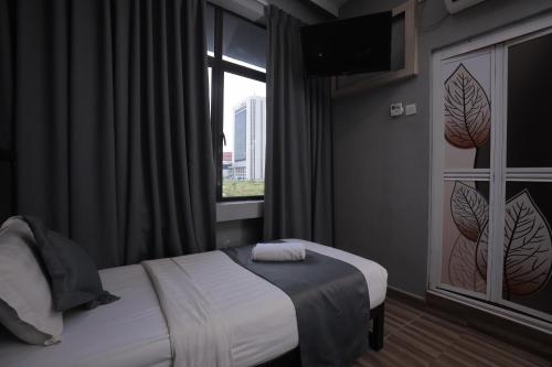 Ένα ή περισσότερα κρεβάτια σε δωμάτιο στο DJ Citi Inn Premier