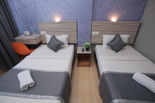 Ένα ή περισσότερα κρεβάτια σε δωμάτιο στο DJ Citi Inn Premier