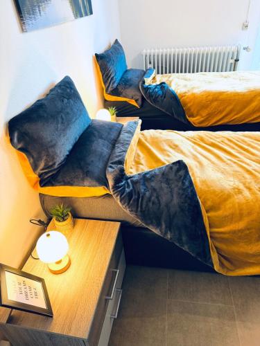 two beds with pillows on them in a room at Apartment Schwarzwaldhöhen Pforzheim-Birkenfeld in Birkenfeld