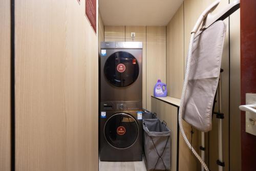 a washer and dryer in a small room at Chinese Culture Boutique Hotel-Tangfu,Traditional Chinese Theme,Heart of Beijing,Near Forbidden City,Tiananmen Square,Hutongs,Metro Access,Free Coffee,tea,Laundry in Beijing
