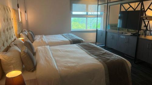 a hotel room with two beds and a television at Landmark Bhairahawa in Bhairāhawā